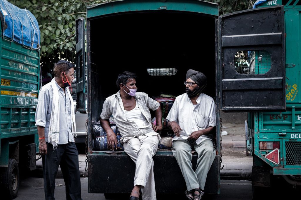 three men sitting inside a truck and talking_social sector