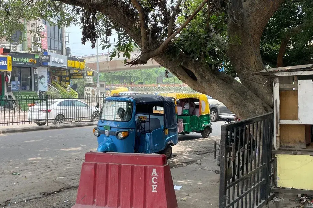 An e-rickshaw in front of a CNG auto in South Delhi.