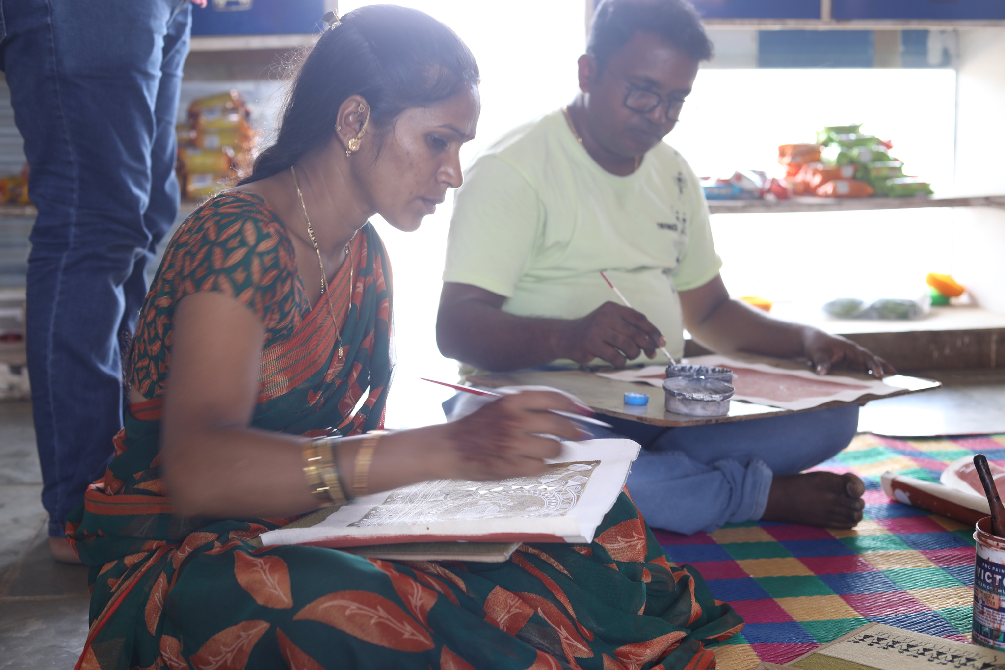 a woman doing warli painting_digital financial institution