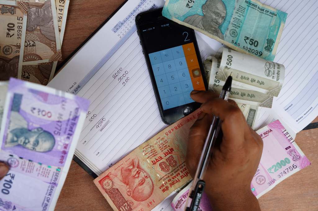 financial calculations with a smartphone and pen and paper--msme credit access