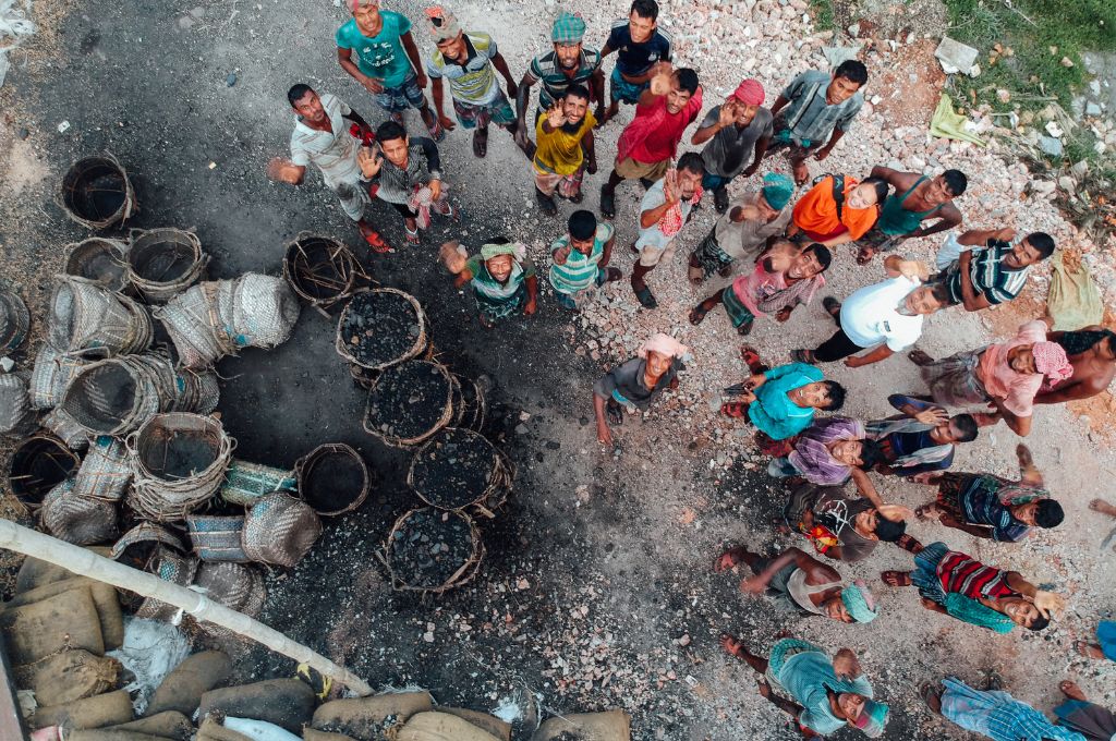 people stading near bags of coal and looking up_just transition