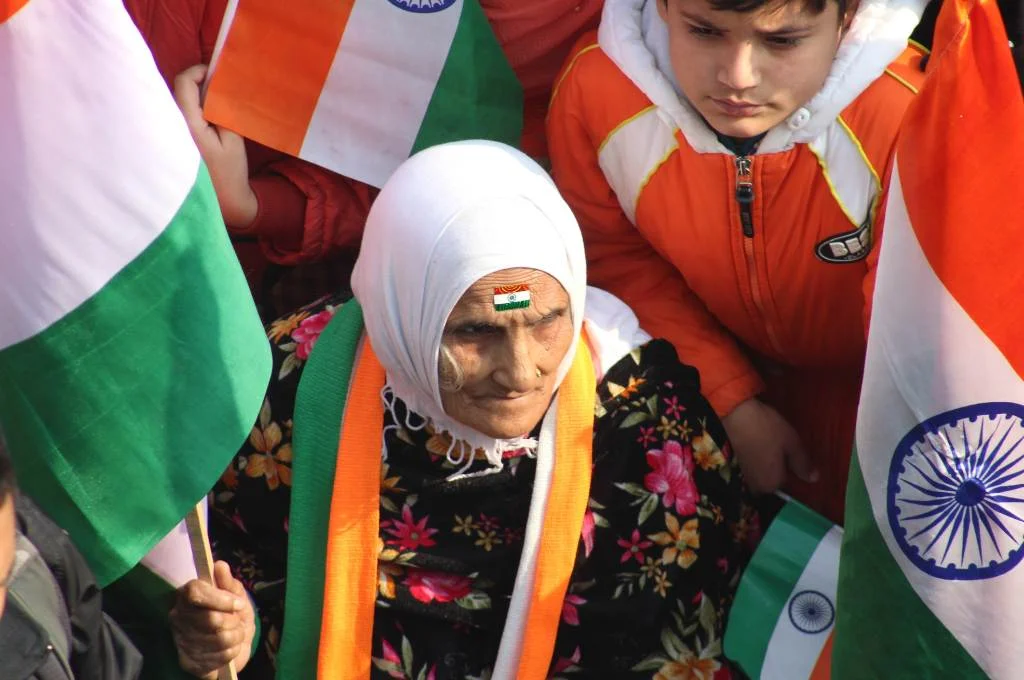 an old woman holding the indian flag--india political system