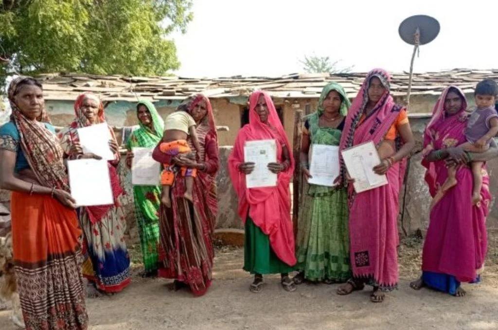 Adivasi people showing IFR papers--land rights
