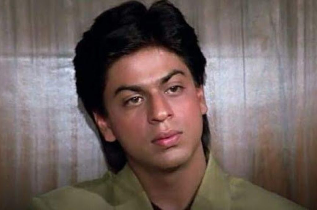 a young shah rukh khan looking deadpan--nonprofit humour