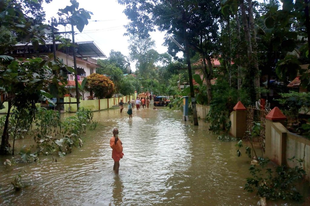 people walking in a flooded road_disaster management