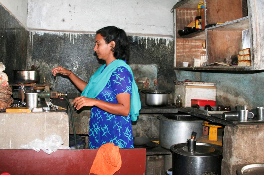 a woman cooking in a kitchen--migration