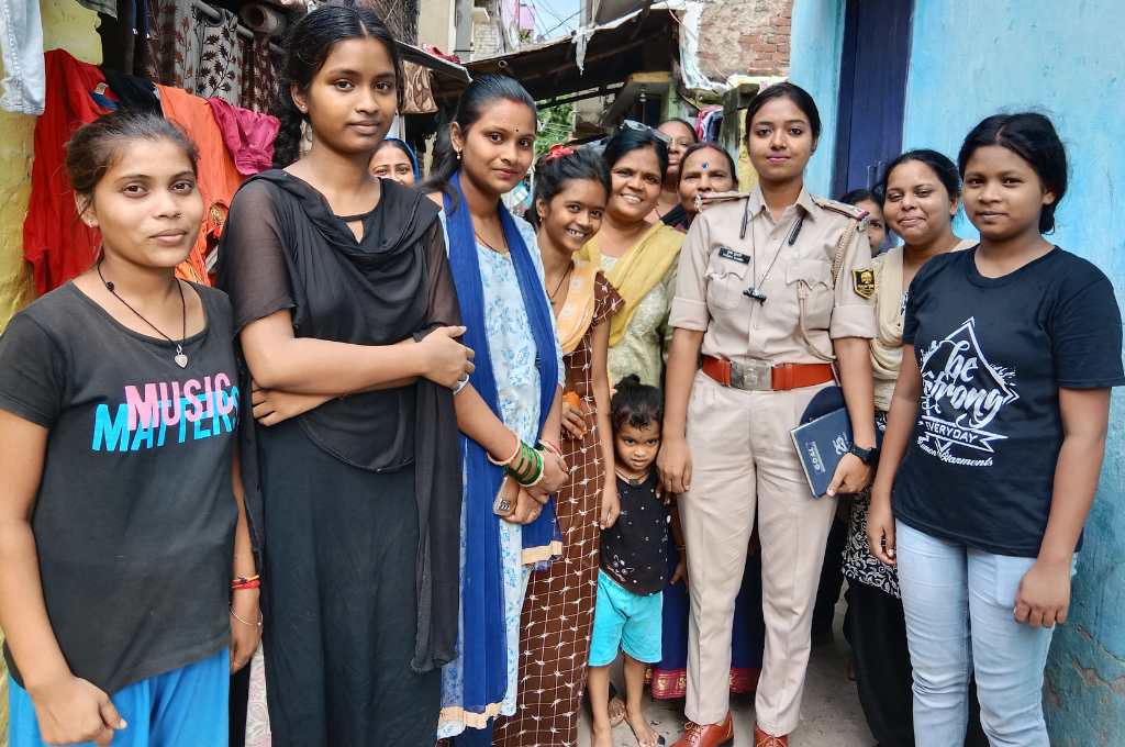 girls standing with mothers and a policewoman-girl empowerment