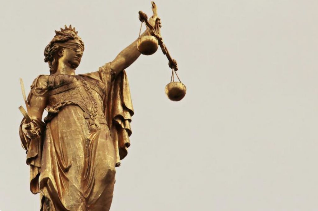 a stature of lady justice holding a weighing scale-digital