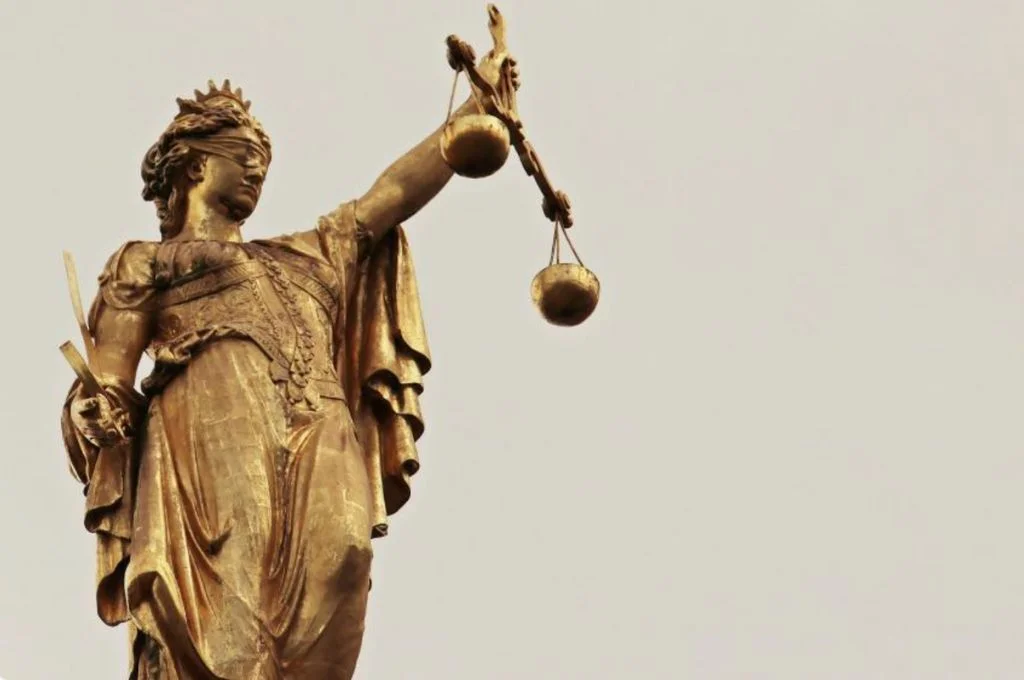 a stature of lady justice holding a weighing scale-digital