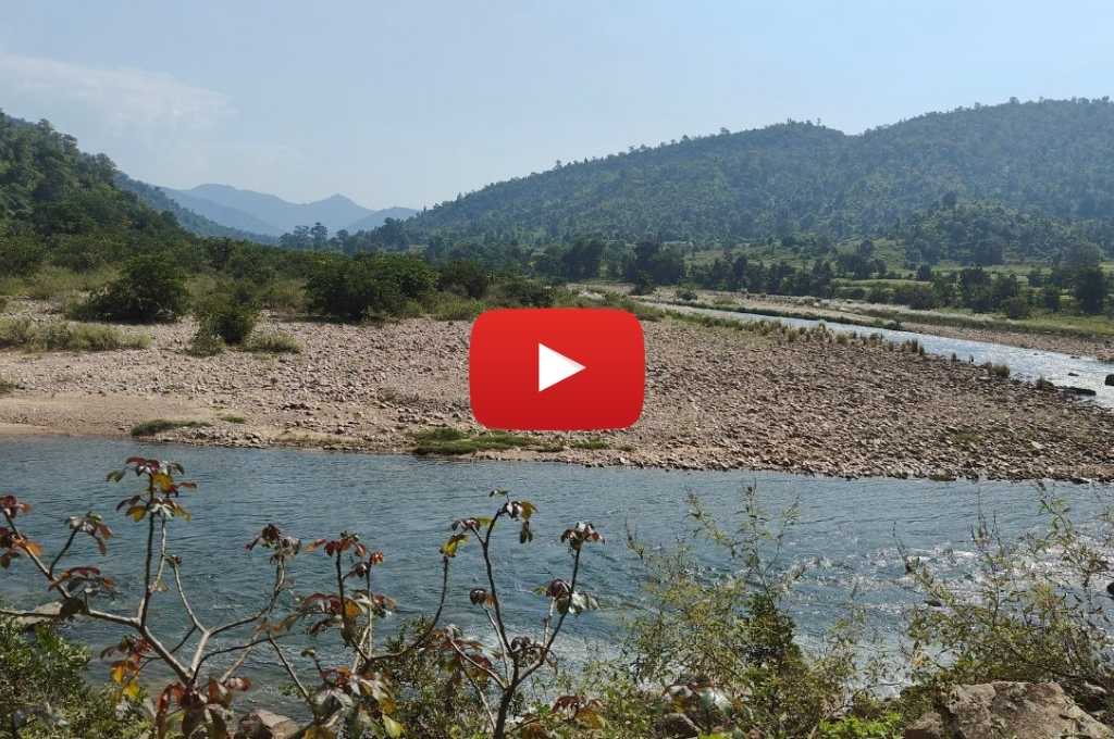 A landscape with a river and mountains_forest rights act