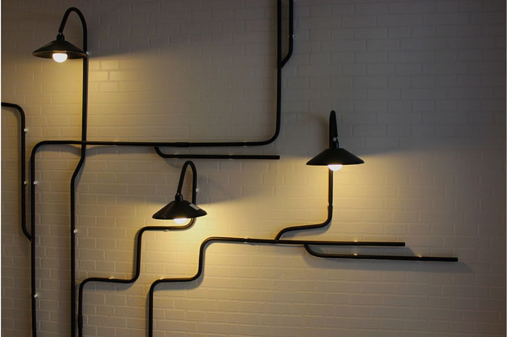 many squiggly lamps against a wall-impact measurement