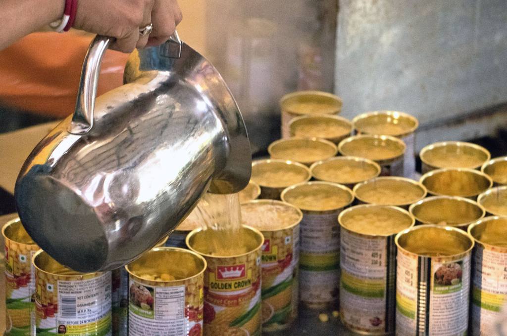 water pouring into cans of corn--FPOs