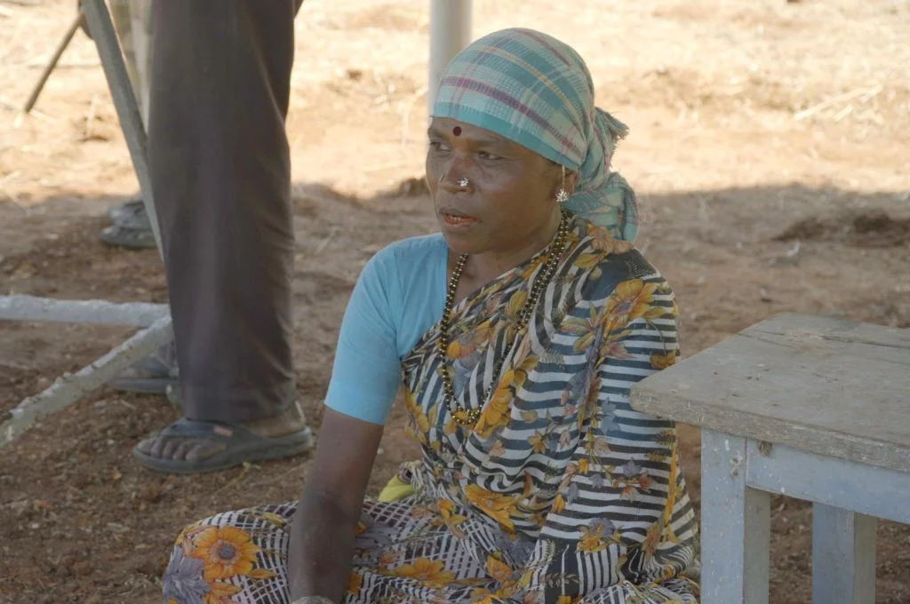 madamma, a woman from the iruliga community, sitting on the ground and engaging in conversation--bannerghatta conservation