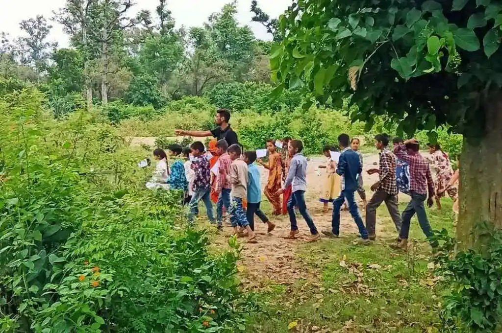 man walking with children in a forest-vann gujjars