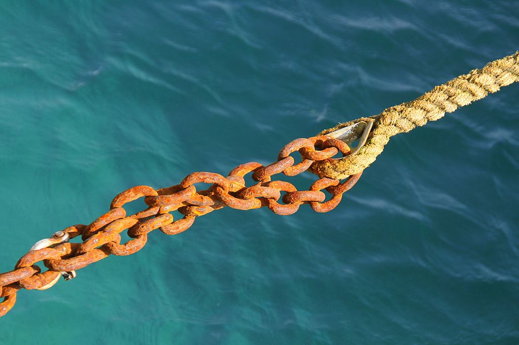 a rusty chain and a rope pulling at each other--philanthropy