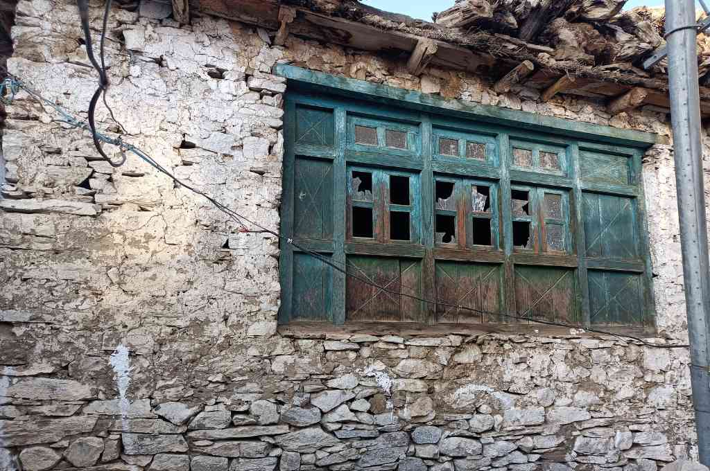 A stone house with large windows_spiti architecture