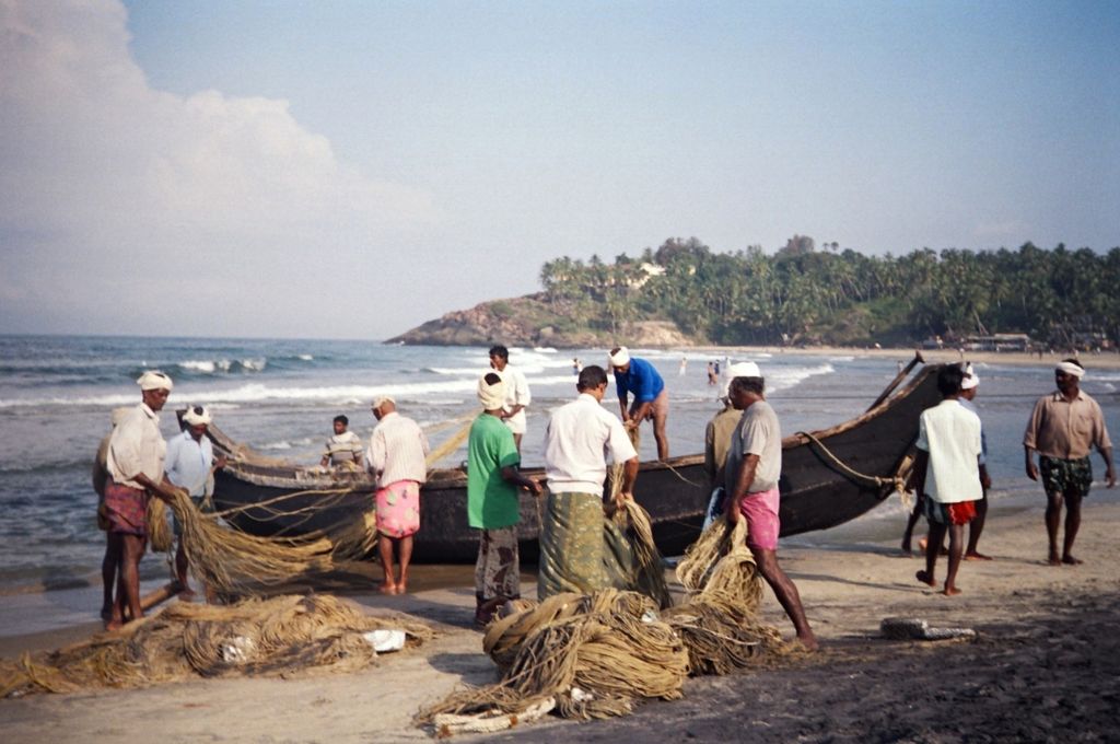 a group of men fishing_coastal commons
