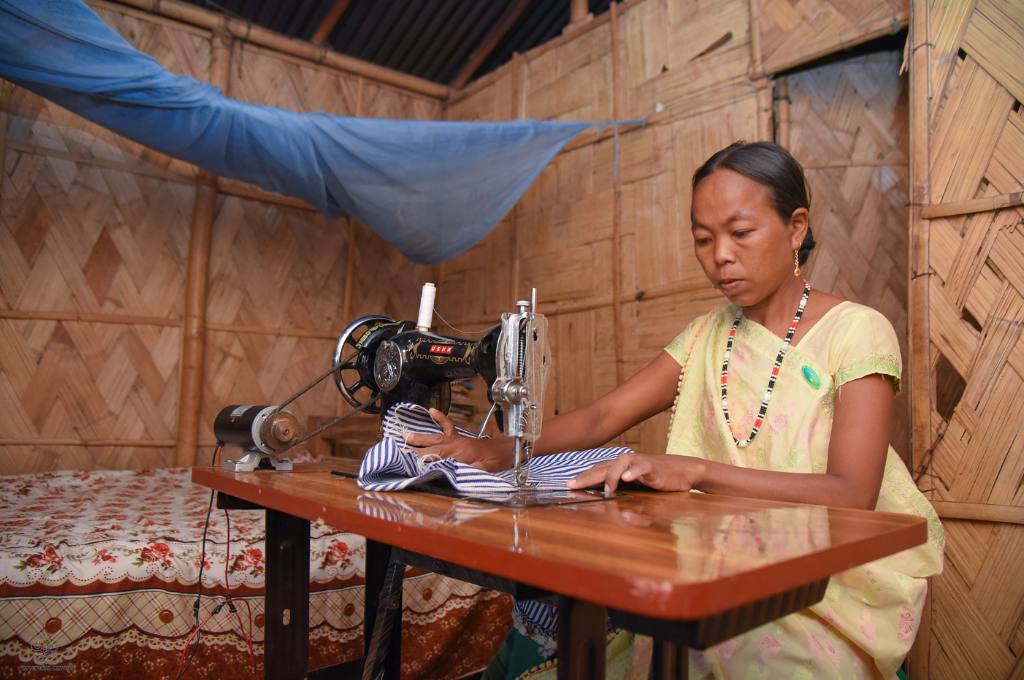 a woman with a solar-powered sewing machine--decentralised renewable energy
