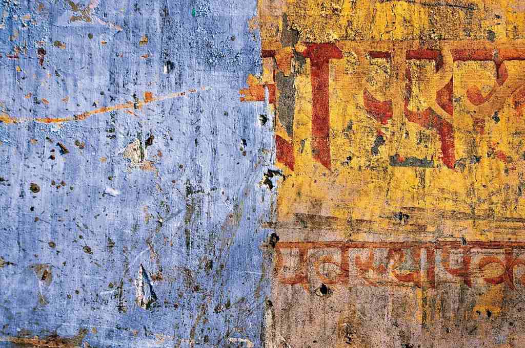 a blue and yellow wall with devnagri script--csr expenditure in india