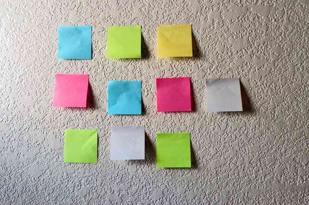 10 colourful post-it notes stuck on a white wall-digital crowdfunding