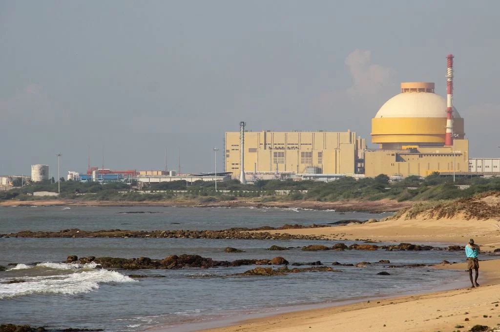 a man walks along the coast with the Kudankulam Nuclear Power Plant in the background--union budget 2024-25