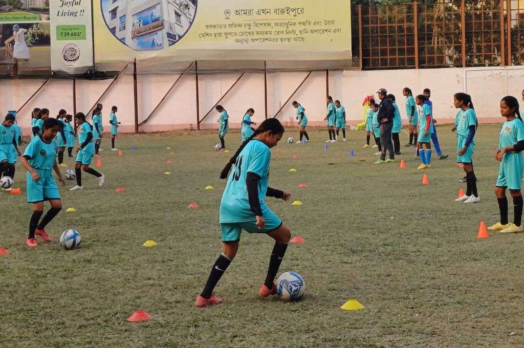 Girls performing football training drills