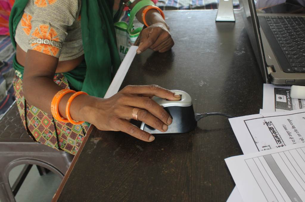 a hand wearing bangles clicking on a computer mouse-financial fraud