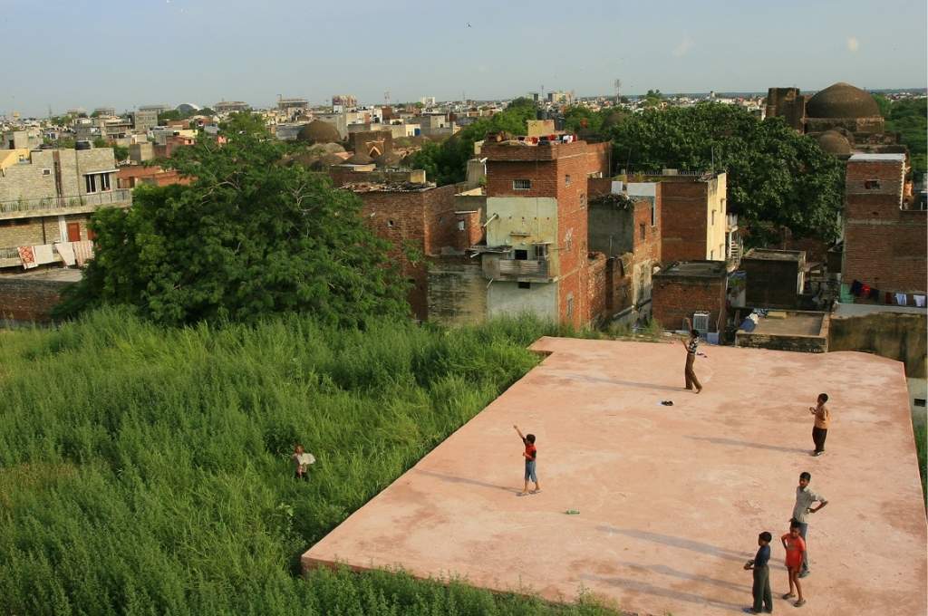 Bird-eye view of a roof with children flying kites_climate action plans