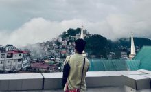 Rodingliana looking at Aizawl's landscape on a cloudy day-language