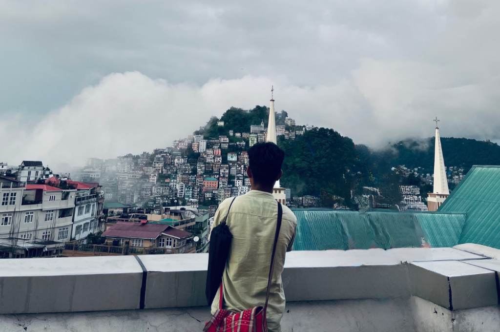 Rodingliana looking at Aizawl's landscape on a cloudy day-language