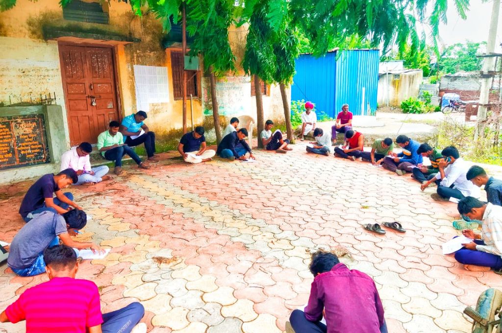 A group of youth sitting in a circle and writing_marginalised youth