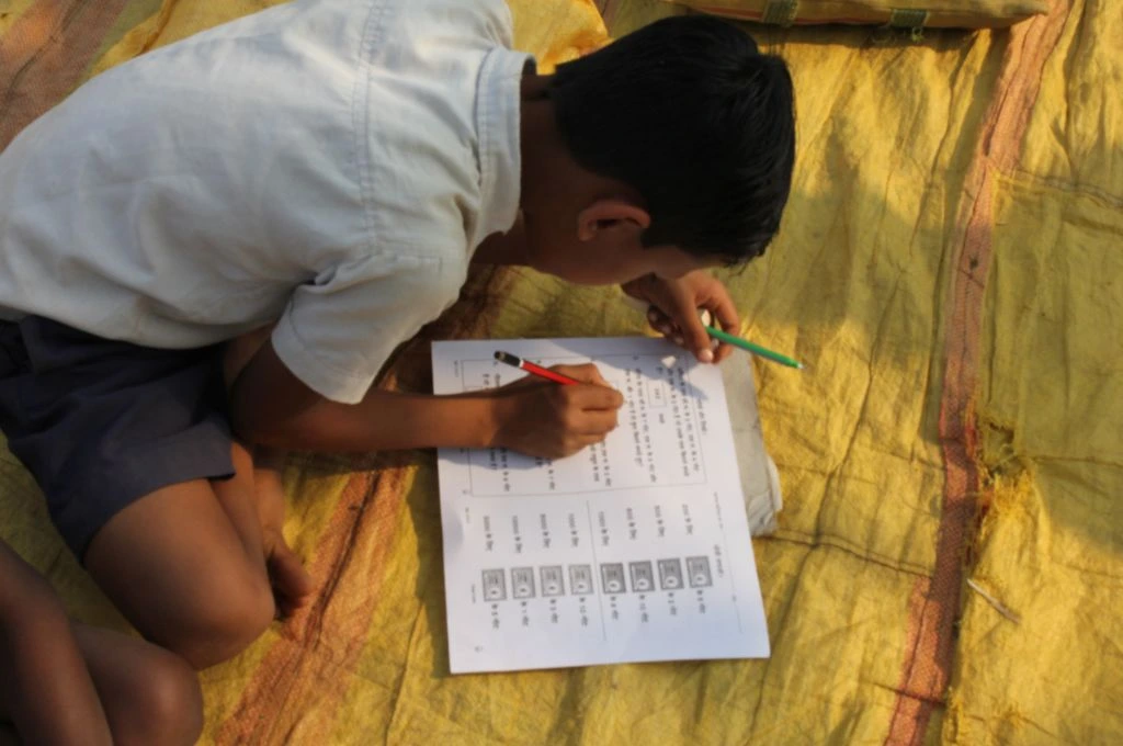 A child writing in his notebook_NEP 2020 