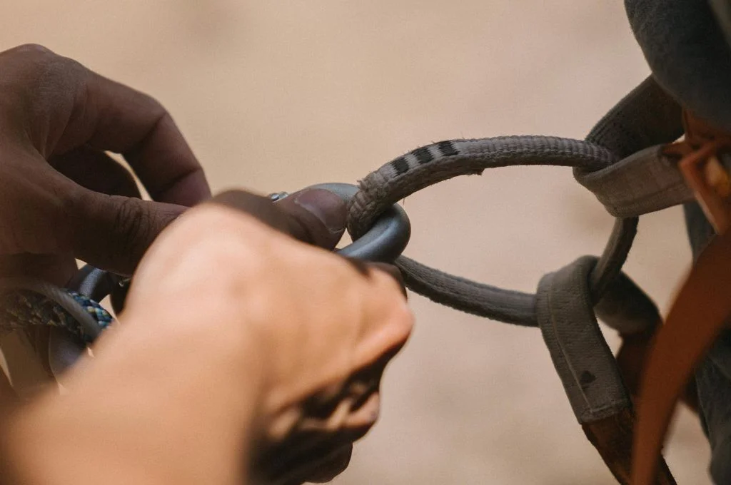 close-up shot of a hand holding climbing gear--risk management