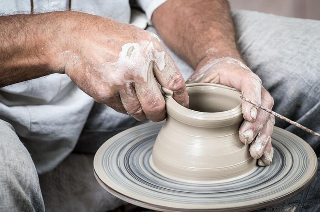 two hands fashioning a clay pot-philanthropy