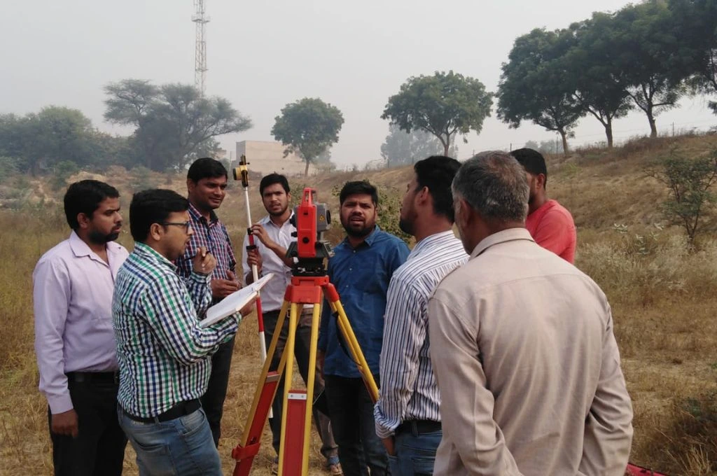 Members of the field team use a total station which is an instrument used to measure vertical and horizontal angles and distances- Water management