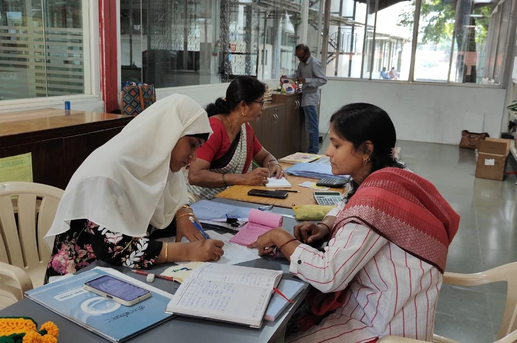 Women microentreprenuers sitting in an office working