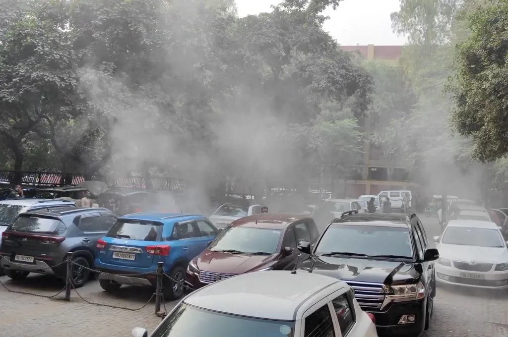 Smoke rises from cars in a parking lot- climate communication