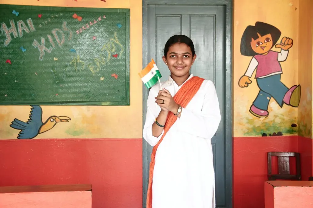 A child holding the Indian flag.- Education system