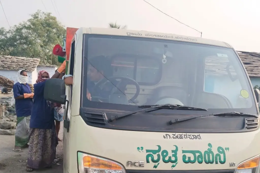 Rural residents interacting with waste collection vehicle_waste management