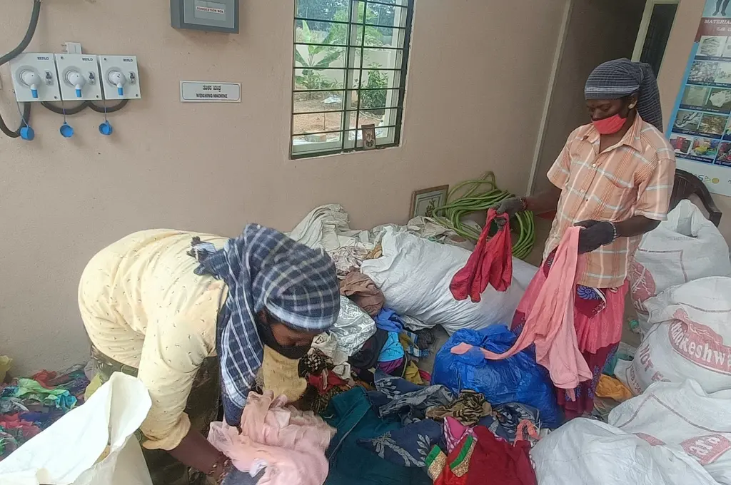 Workers sorting textiles at rural recycling center_waste management