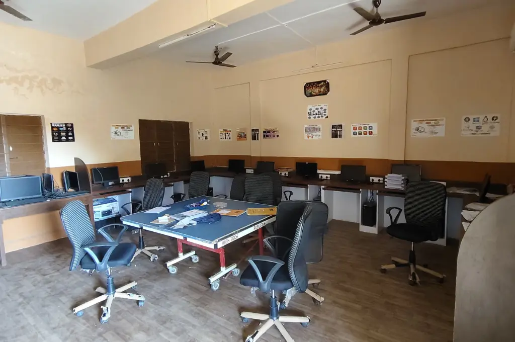 School computer lab with desks and posters_adivasi student