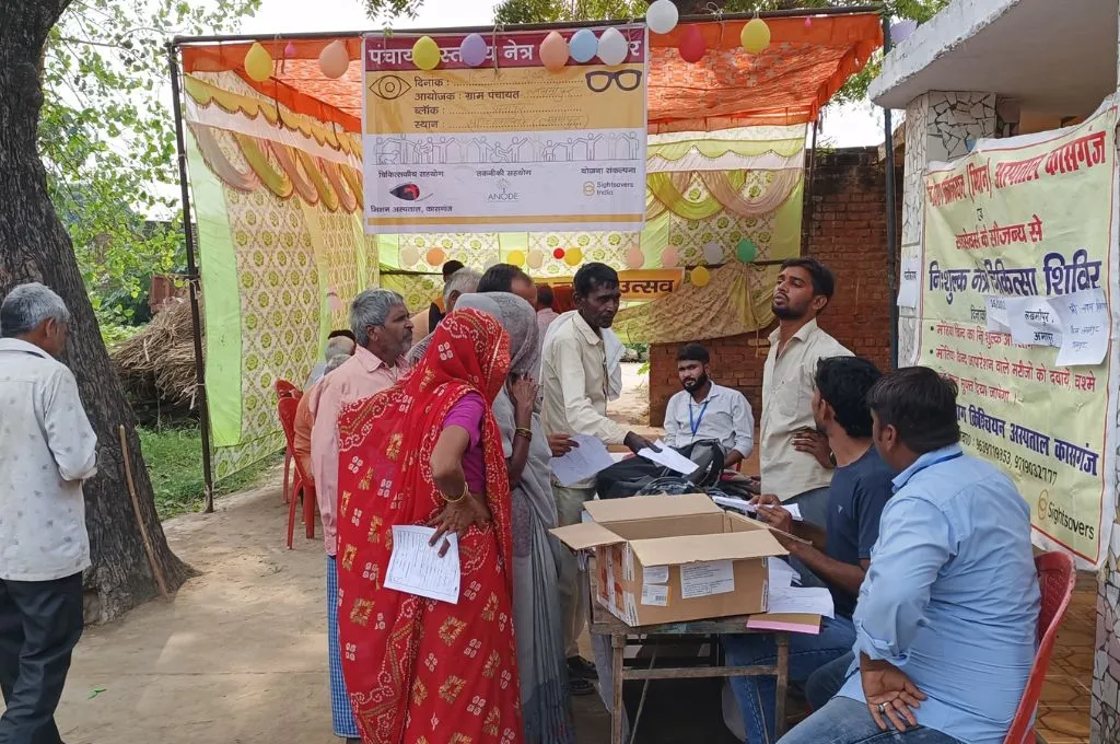 A group of people at a health camp in a village. - Disability inclusion