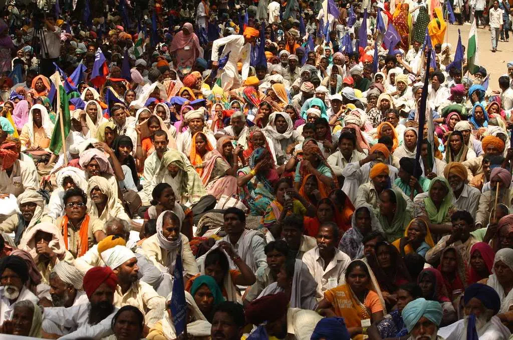 A crowd of people attend a public gathering for a campaign.- Social justice