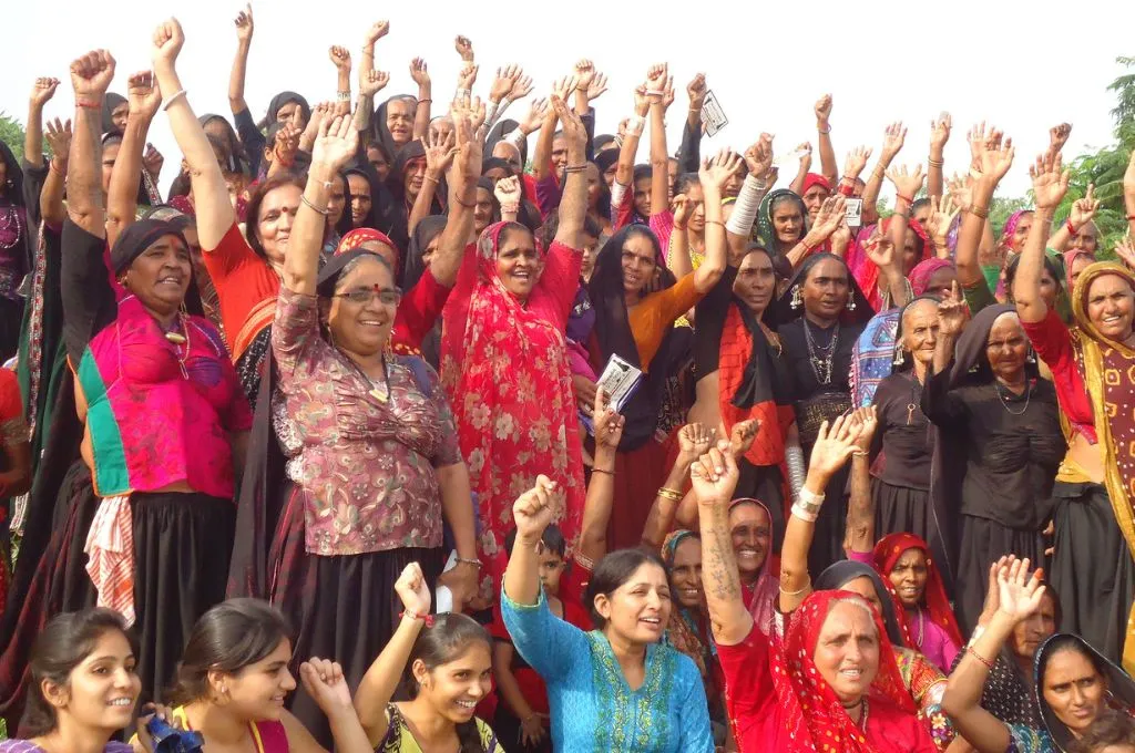 A group of women raising their hands in protest_ecofeminism