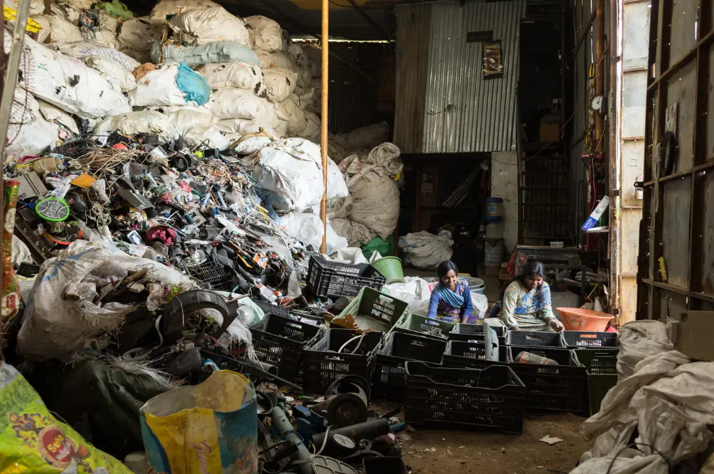 Women sorting electronic waste in a warehouse_waste pickers
