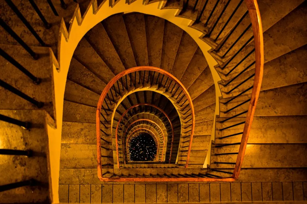 The image is an aerial view of a staircase in a multi-storied building._Grant proposal