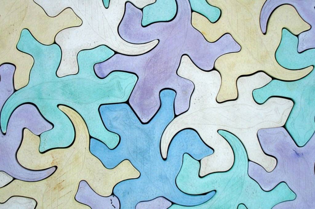 an abstract illustration of interlinking silhouettes of lizards-global collaboration