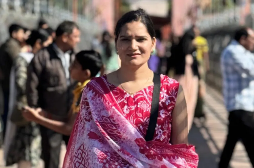 Somya, a young woman, standing on a crowded street with the background blurred--economic inclusion