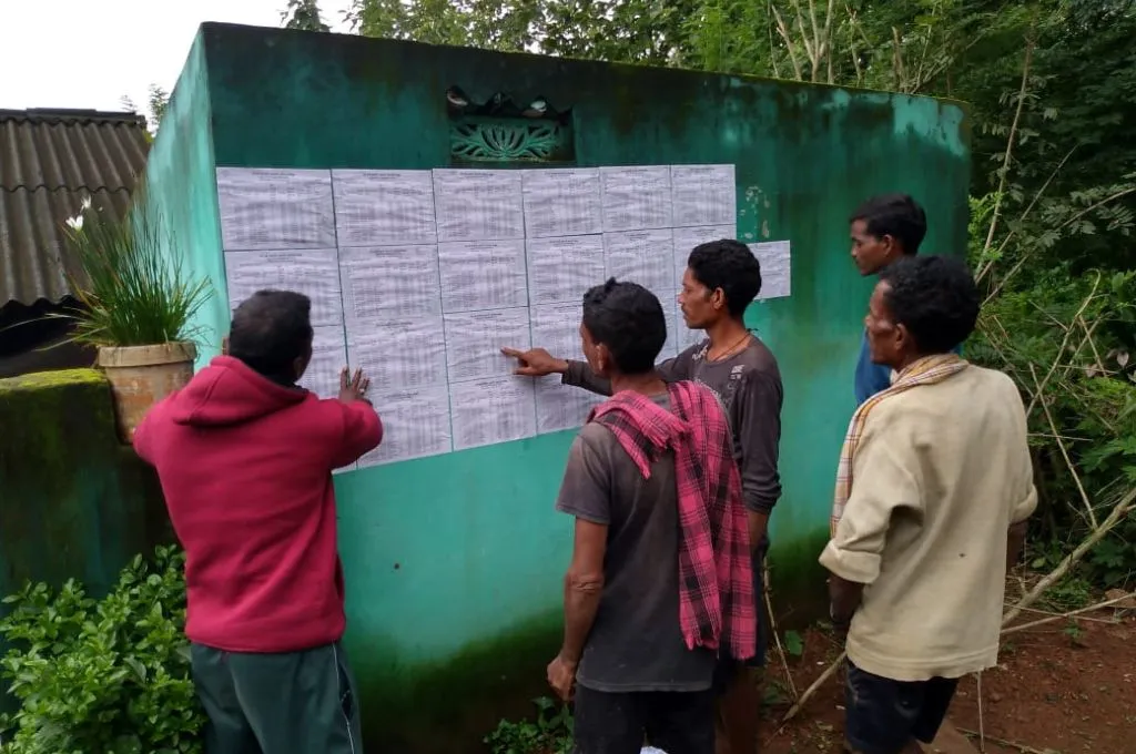 a group of people looking at notices stuck on a wall--ration cards