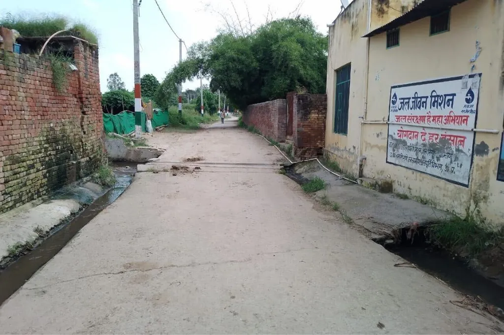 an empty village road with gullies on either side--gramdan